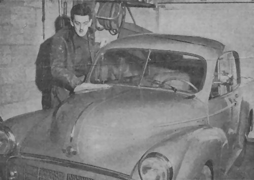 Preparing to return to his job with the U. S. Fish and Wildlife Service in Alaska, Alan Courtright, a former Muskegon Heights High School student, polishes his small British car in the garage of his home at 2436 Jefferson street.  The federal employee, son of Mr. and Mrs. A. M. Courtright, purchased the car while on a recent vacation trip to Europe.  His father is an instructor in the Heights high school.